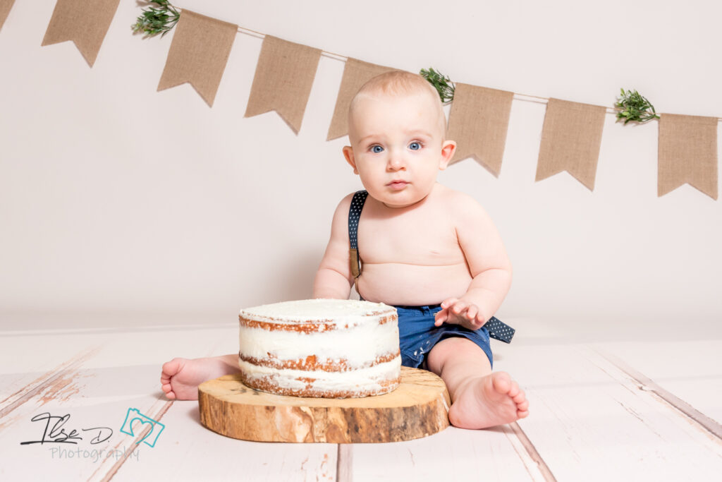 baby in front of cake