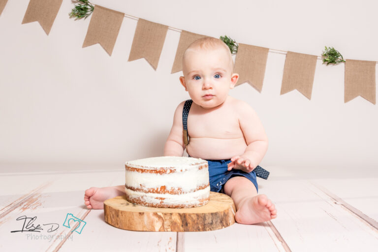 baby in front of cake