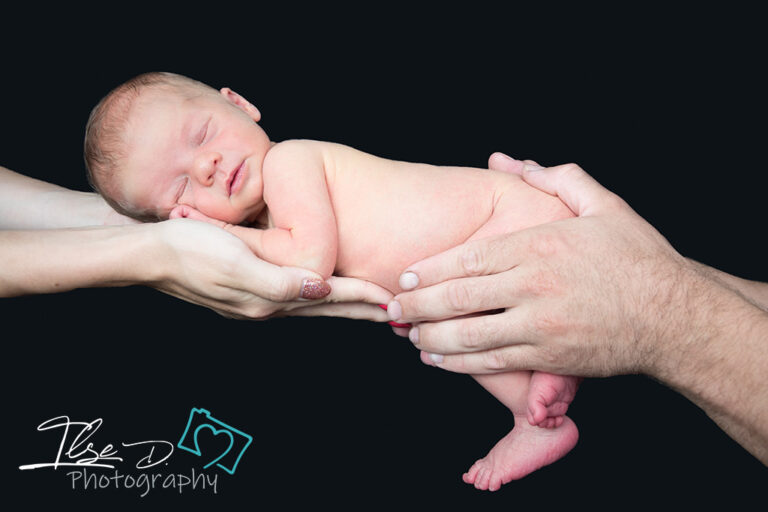 baby held in parents hands